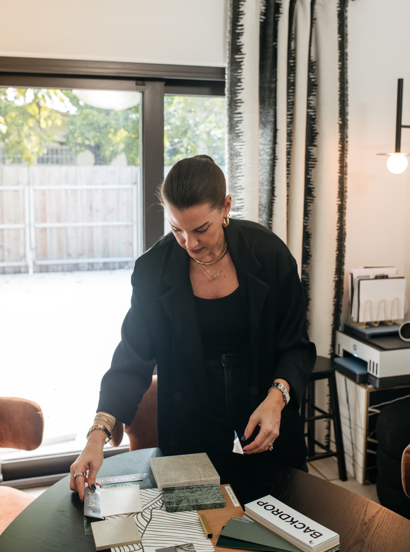 Ann Lopez choosing fabric and stone samples at the Studio 790 materials table