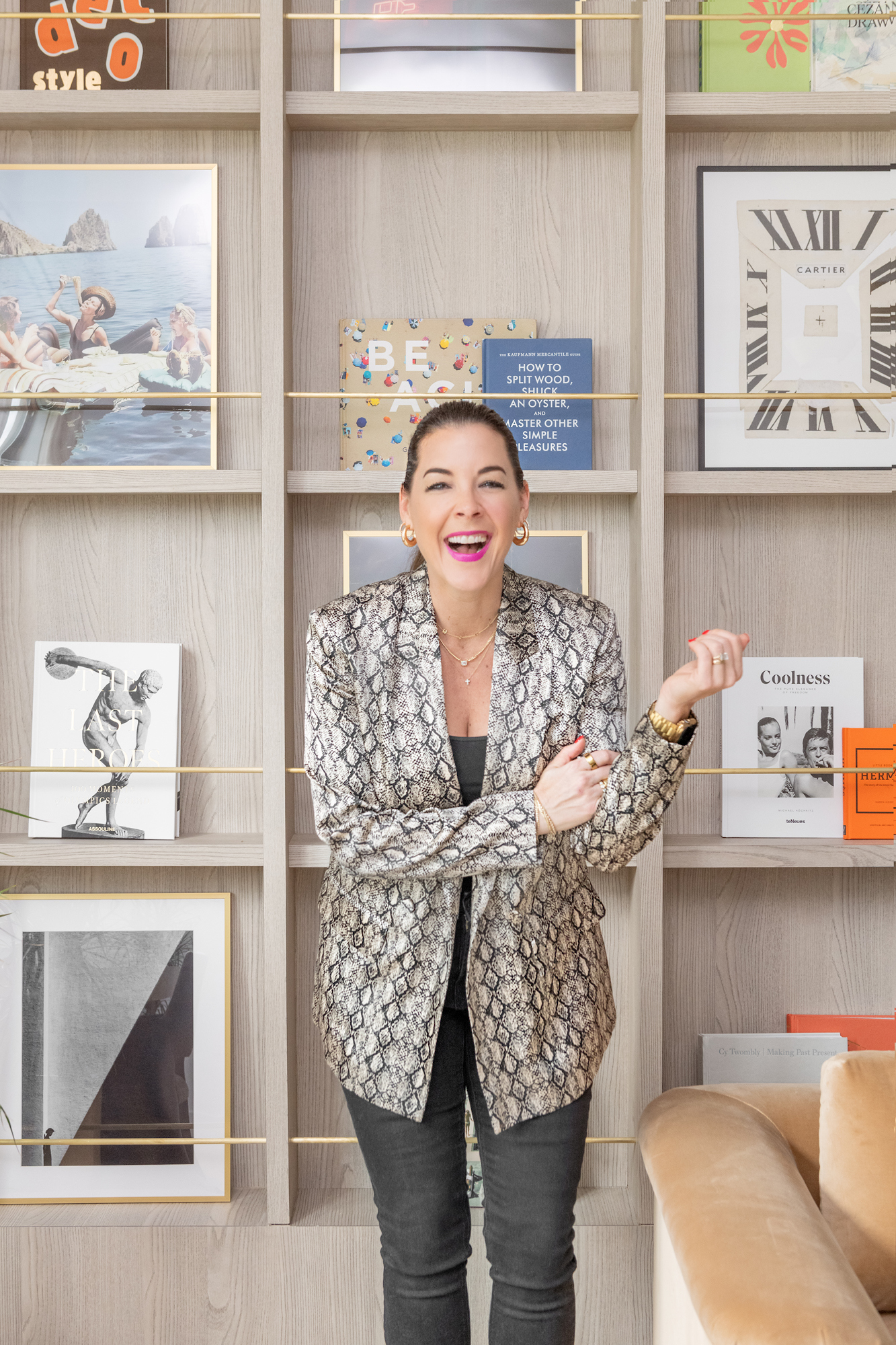 Ann Lopez laughing in front of her bookcase